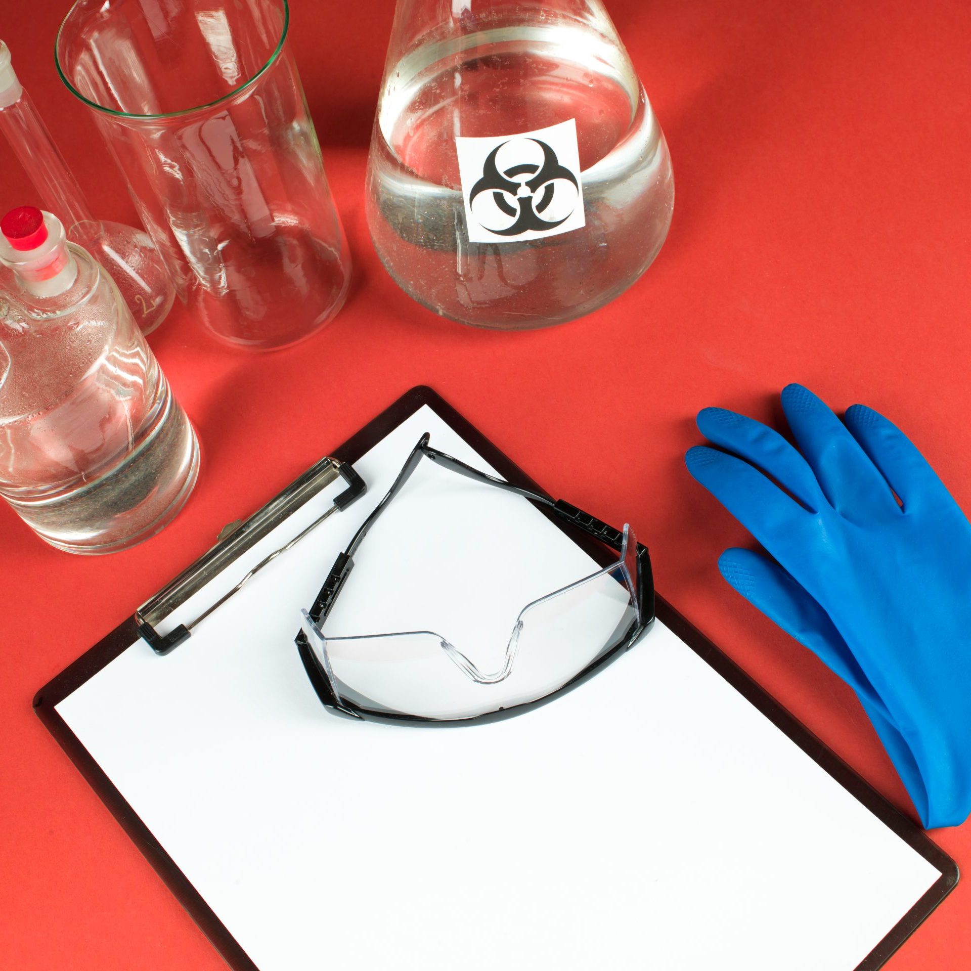 laboratory accessories with blank clipboard and goggles