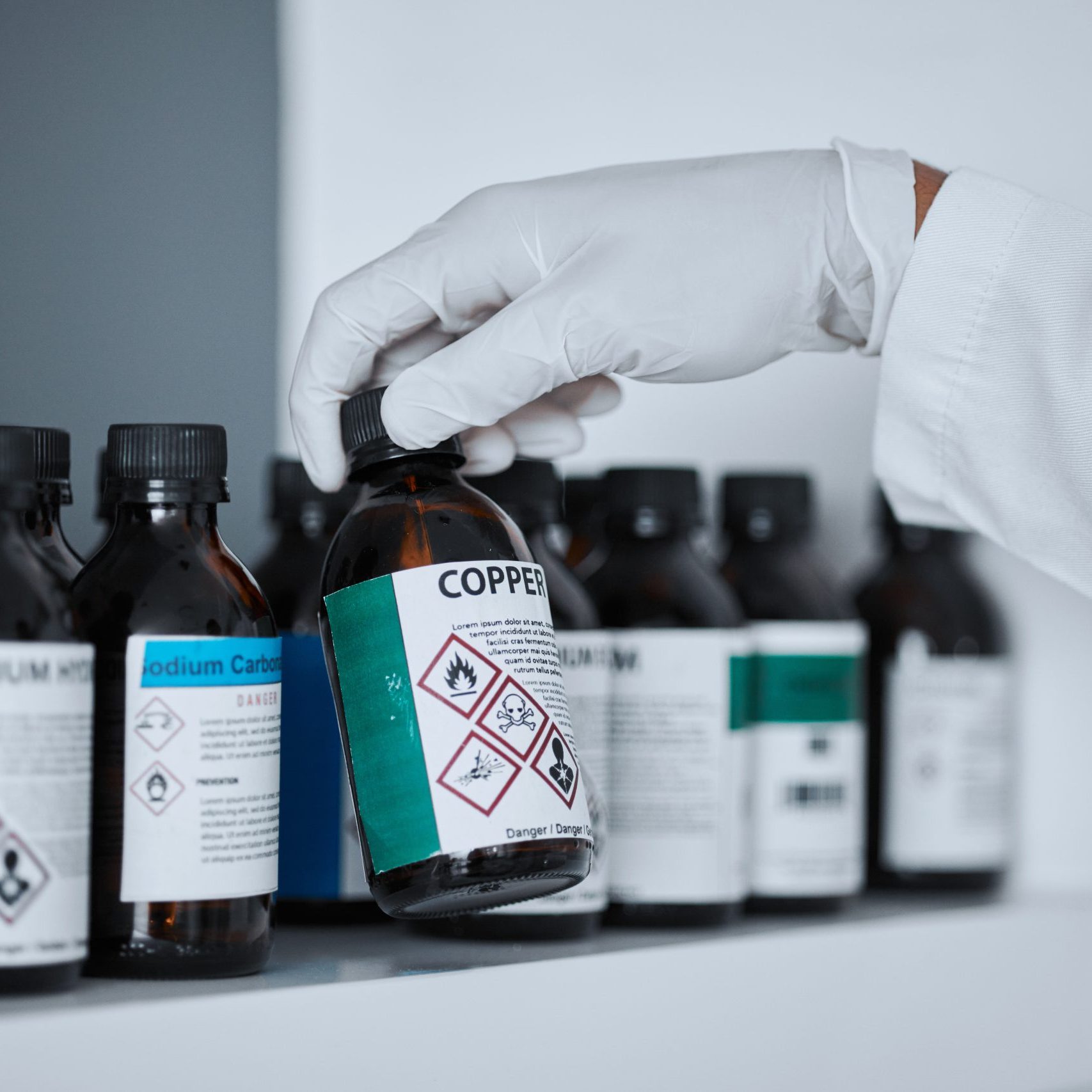 scientist-hand-bottle-and-chemical-on-shelf-in-ph-2025-04-06-12-32-10-utc